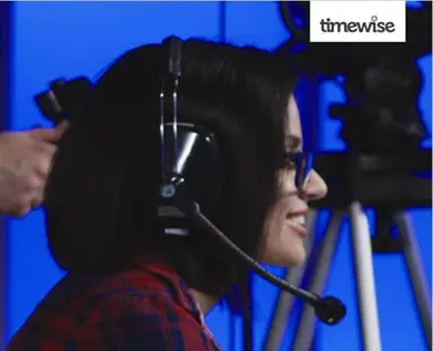 Close Up side on photo of a person with a headset on smiling.