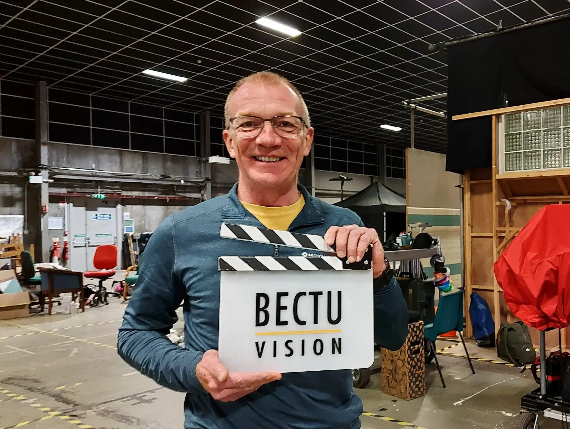 Andrew Patterson holds a BECTU Vision clapperboard