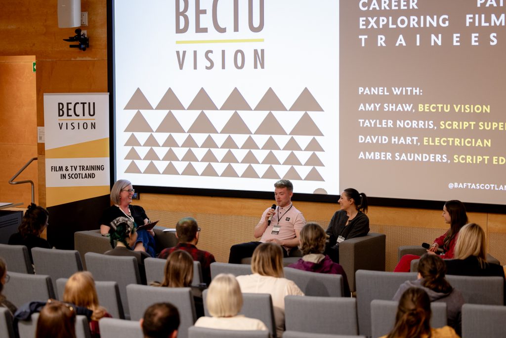 Panel Discussion with large screen behind featuring the BECTU Vision logo