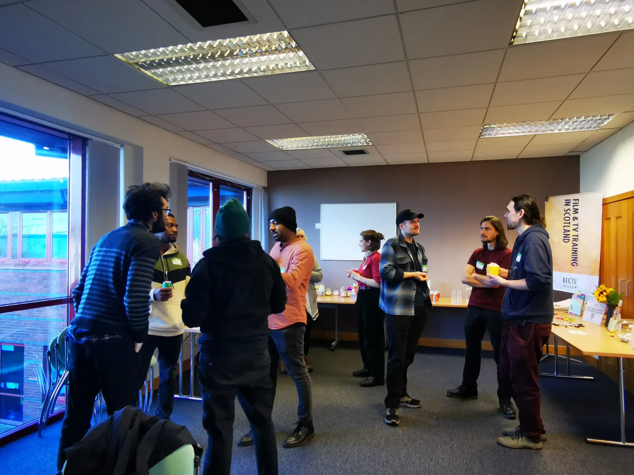 3 groups of people chatting to each other in a meeting room