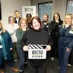 Group shot of British Sign Language for Film & TV Group - tutor Lorna McIntyre (front) holding BECTU Vision clapperboard