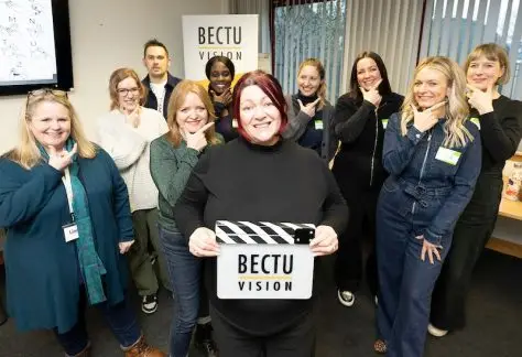 Group shot of British Sign Language for Film & TV Group - tutor Lorna McIntyre (front) holding BECTU Vision clapperboard