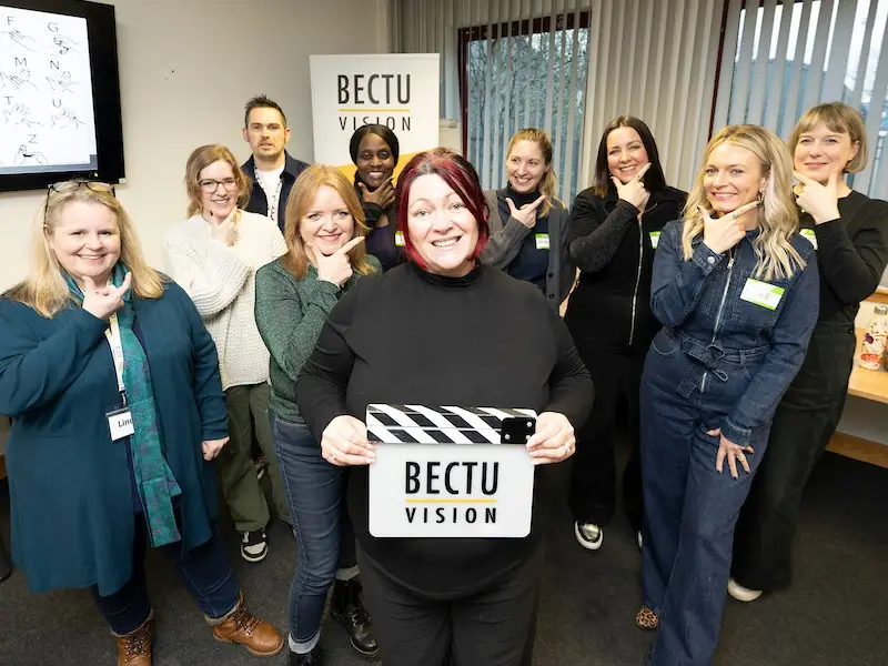 Group shot of British Sign Language for Film & TV Group - tutor Lorna McIntyre (front) holding BECTU Vision clapperboard