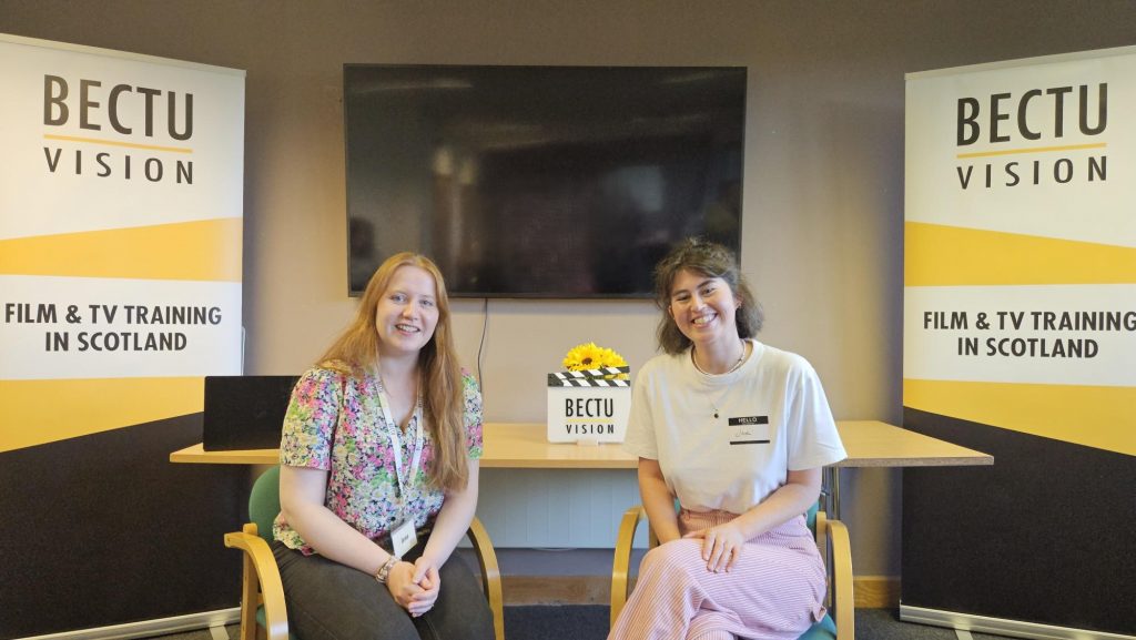 Jena Hunter (left), BECTU Vision's Learning Co-ordinator who looks after the New Entrants' Base activity and Jodi Webster (right) who works in the Art Department smiling at the camera whilst sittiing at the front of the meeting room after the Question and Answer session