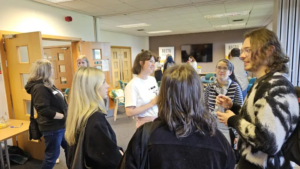 Groups of attendees of the Saturday Drop-in networking with peers and making industry contacts