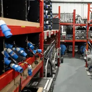Electrical cables, distribution boxes, and flight cases on shelving