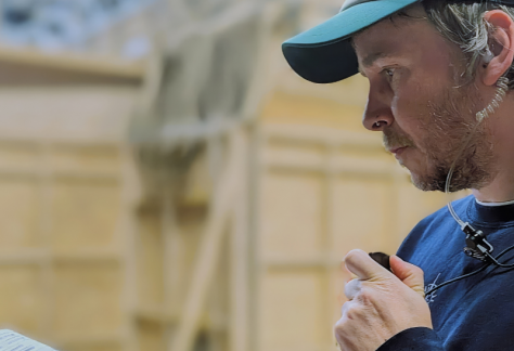Mark O'Connor - Assistant Director, wears a covert radio ear piece.